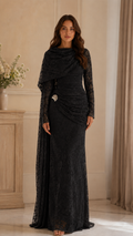Front view of black lace maxi gown with gathered hip detail and decorative side accent